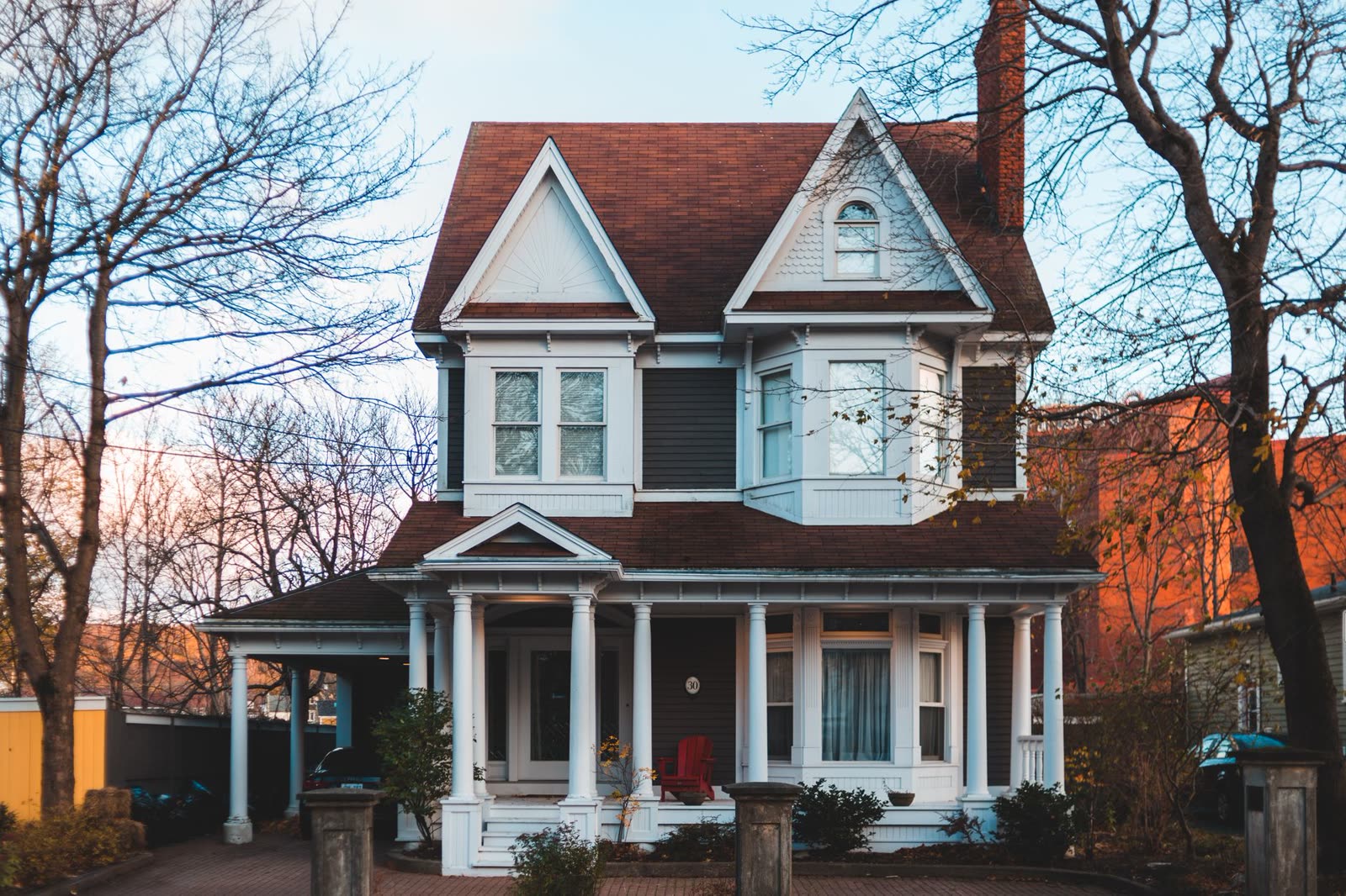 family sitting on a front porch on a mild autumn evening / people in short sleeves walking a southern downtown street at dusk / low clouds glowing over a small southern town at sunrise